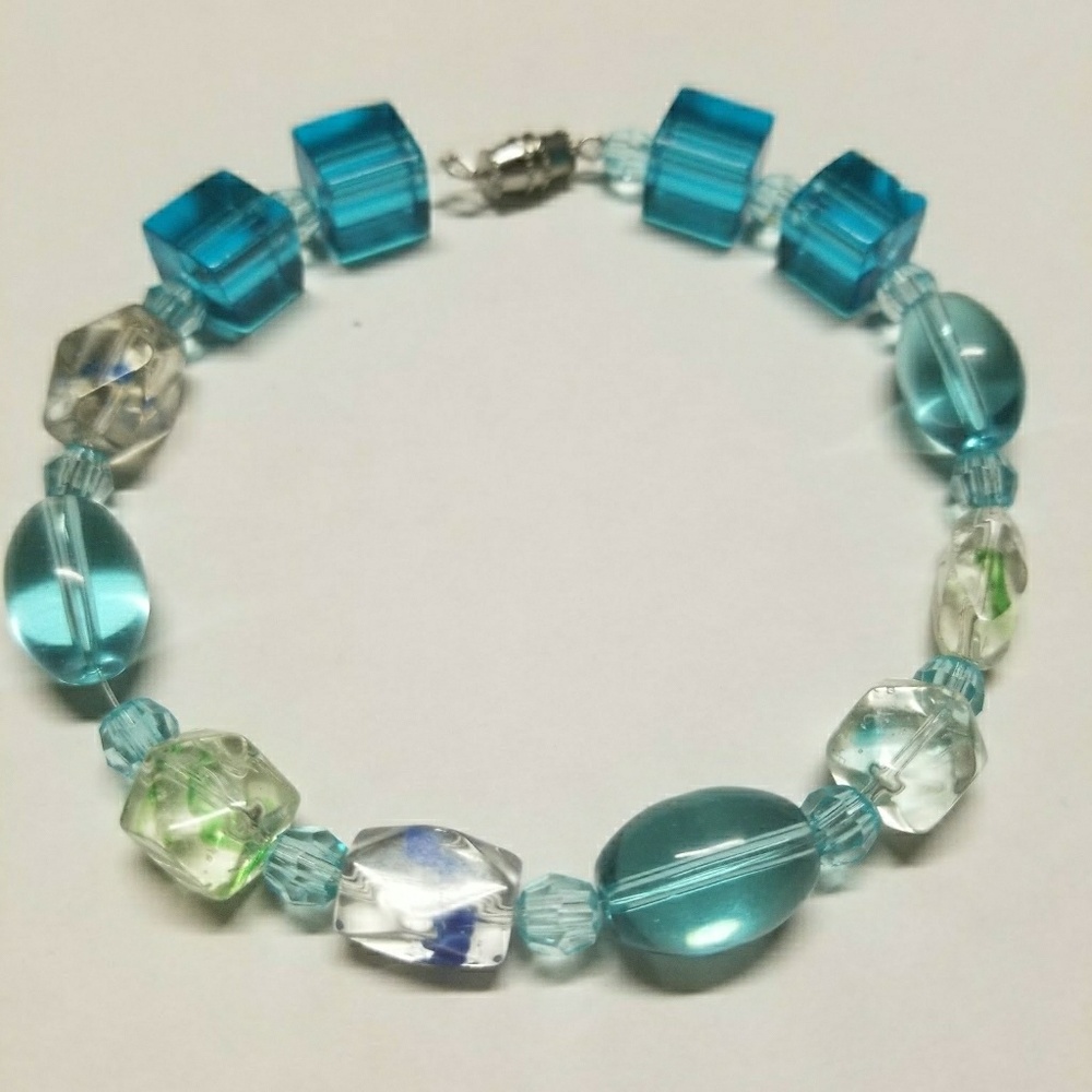 A LARGE glass beaded bracelet
